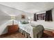 Bedroom with natural light, two side tables with lamps, wood floors, and curtains at 107 N Harris St # 306, Breckenridge, CO 80424