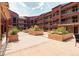 Beautiful condo courtyard featuring planter boxes with greenery, red exterior walls, and community space at 107 N Harris St # 306, Breckenridge, CO 80424