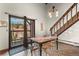 Dining room featuring a chandelier, exterior access to a balcony, and view of the staircase at 107 N Harris St # 306, Breckenridge, CO 80424