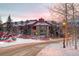 Inviting multi-story building with snow-covered roofs and cozy lighting creating a warm winter scene at 107 N Harris St # 306, Breckenridge, CO 80424