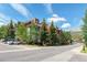 Exterior shot of condo building with surrounding green trees under bright blue skies at 107 N Harris St # 306, Breckenridge, CO 80424