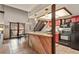 View of the kitchen featuring black appliances, breakfast bar, and dining area with large windows at 107 N Harris St # 306, Breckenridge, CO 80424