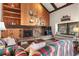 Living room featuring a stone fireplace, wood paneled wall, and built-in shelves for storage at 107 N Harris St # 306, Breckenridge, CO 80424