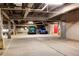 Underground parking garage with a red door leading to locker room area at 107 N Harris St # 306, Breckenridge, CO 80424