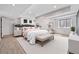 Primary bedroom featuring wood floors, tray ceiling, and an abundance of natural light at 13275 Holly St # B, Thornton, CO 80241