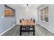 Bright dining area with modern light fixture, a wooden table and gray vinyl plank flooring at 13275 Holly St # B, Thornton, CO 80241