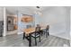 This dining room has a wooden table, grey vinyl plank flooring, and flows into the kitchen at 13275 Holly St # B, Thornton, CO 80241