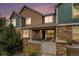 Charming two-story townhome featuring stone accents and a covered front porch at 13275 Holly St # B, Thornton, CO 80241