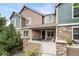 Charming townhome exterior featuring stone accents and a cozy front porch at 13275 Holly St # B, Thornton, CO 80241