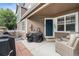 Inviting front porch with seating, a grill, and a view of the entrance at 13275 Holly St # B, Thornton, CO 80241