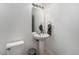 This half bathroom features a pedestal sink, tiled floors and fresh white paint at 13275 Holly St # B, Thornton, CO 80241