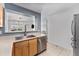 The kitchen boasts stainless steel appliances and a sink overlooking the dining and living area at 13275 Holly St # B, Thornton, CO 80241