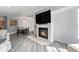 Open concept living room with fireplace, dining area, and modern lighting at 13275 Holly St # B, Thornton, CO 80241