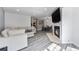 Open-concept living space featuring a fireplace and connection to the dining area at 13275 Holly St # B, Thornton, CO 80241