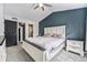The main bedroom offers a calming navy accent wall and updated walk in closet and bathroom at 13275 Holly St # B, Thornton, CO 80241