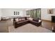 Finished basement featuring a sectional couch, a fireplace, and outdoor views at 6016 Stone Creek Dr, Evergreen, CO 80439