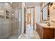 Bathroom featuring wood accents, glass shower with tile, and a vessel sink at 6016 Stone Creek Dr, Evergreen, CO 80439