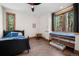 Cozy bedroom with large window and window seat, wood trim, and a black bed frame at 6016 Stone Creek Dr, Evergreen, CO 80439