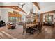 Elegant dining area with natural light and hardwood floors open to the living room at 6016 Stone Creek Dr, Evergreen, CO 80439