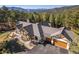 Luxury home with stone and timber accents nestled in a scenic landscape with mountain views at 6016 Stone Creek Dr, Evergreen, CO 80439