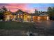 Stunning exterior of home with stone accents, inviting entry, and well-manicured lawn at 6016 Stone Creek Dr, Evergreen, CO 80439