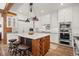 Charming kitchen with a marble-topped island, wooden accents, and stainless steel appliances at 6016 Stone Creek Dr, Evergreen, CO 80439