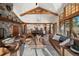 Bright and airy living room with vaulted ceiling, wood beams, and large windows at 6016 Stone Creek Dr, Evergreen, CO 80439