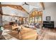 Open-concept living area with hardwood floors, a piano, and access to outdoor space at 6016 Stone Creek Dr, Evergreen, CO 80439