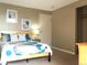 Cozy bedroom featuring a comfortable bed, neutral tones, and two lovely matching framed prints at 2225 Buchtel Blvd # 202, Denver, CO 80210