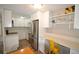 Well-lit kitchen featuring modern stainless steel appliances, white cabinetry, and an adjacent workspace at 2225 Buchtel Blvd # 202, Denver, CO 80210