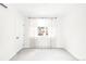 Bright bedroom with neutral tones, featuring a window with sheer curtains and a built in a/c unit at 3955 W 13Th Ave, Denver, CO 80204