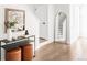Inviting entryway with stylish console table, mirror, and staircase in a modern design at 3955 W 13Th Ave, Denver, CO 80204
