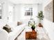 Bright living room featuring a stylish white sofa, wood accent table, and contemporary decor at 3955 W 13Th Ave, Denver, CO 80204