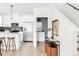 Open-concept living space with a view of the kitchen, powder room and staircase at 3955 W 13Th Ave, Denver, CO 80204