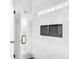 Modern shower with hexagonal tile, glass door, and built-in niche at 3955 W 13Th Ave, Denver, CO 80204