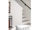 Close up view of a modern style, white staircase with wood treads at 3955 W 13Th Ave, Denver, CO 80204