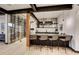 Stylish bar area with counter seating, wine storage, and modern lighting fixtures at 2300 Boreas Pass Rd, Breckenridge, CO 80424