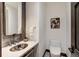 Elegant powder room featuring a marble countertop and decorative fixtures at 2300 Boreas Pass Rd, Breckenridge, CO 80424