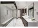 Modern bathroom with a glass shower and dual sink vanity with marble counters at 2300 Boreas Pass Rd, Breckenridge, CO 80424