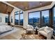 Bright bedroom with vaulted wood ceiling and large windows showcasing mountain views at 2300 Boreas Pass Rd, Breckenridge, CO 80424