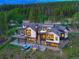 Luxury home featuring an outdoor hot tub, fire pit, and views of surrounding forest at 2300 Boreas Pass Rd, Breckenridge, CO 80424