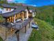 Luxury home featuring an outdoor hot tub, fire pit, and views of surrounding forest at 2300 Boreas Pass Rd, Breckenridge, CO 80424