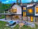 Luxury home featuring an outdoor hot tub, fire pit, and views of surrounding forest at 2300 Boreas Pass Rd, Breckenridge, CO 80424