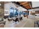 Open-concept living area featuring a stone fireplace, high ceilings, and mountain views, perfect for entertaining at 2300 Boreas Pass Rd, Breckenridge, CO 80424