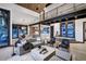 Cozy living room with loft, stone accents, comfortable seating, and an open layout leading to the dining area at 2300 Boreas Pass Rd, Breckenridge, CO 80424