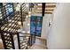 Modern staircase with wooden steps, black metal railings, and unique pendant lights at 2300 Boreas Pass Rd, Breckenridge, CO 80424