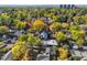 A breathtaking aerial view of a neighborhood showcasing colorful fall foliage and tree-lined streets at 536 S Vine St, Denver, CO 80209