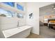 Bright bathroom features a luxurious soaking tub and modern finishes next to the main bedroom at 536 S Vine St, Denver, CO 80209