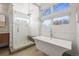 Bright bathroom features a luxurious soaking tub, walk-in shower, and modern finishes at 536 S Vine St, Denver, CO 80209