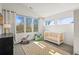 Bright Bedroom bedroom features a large window, and a cozy rocking chair and crib at 536 S Vine St, Denver, CO 80209
